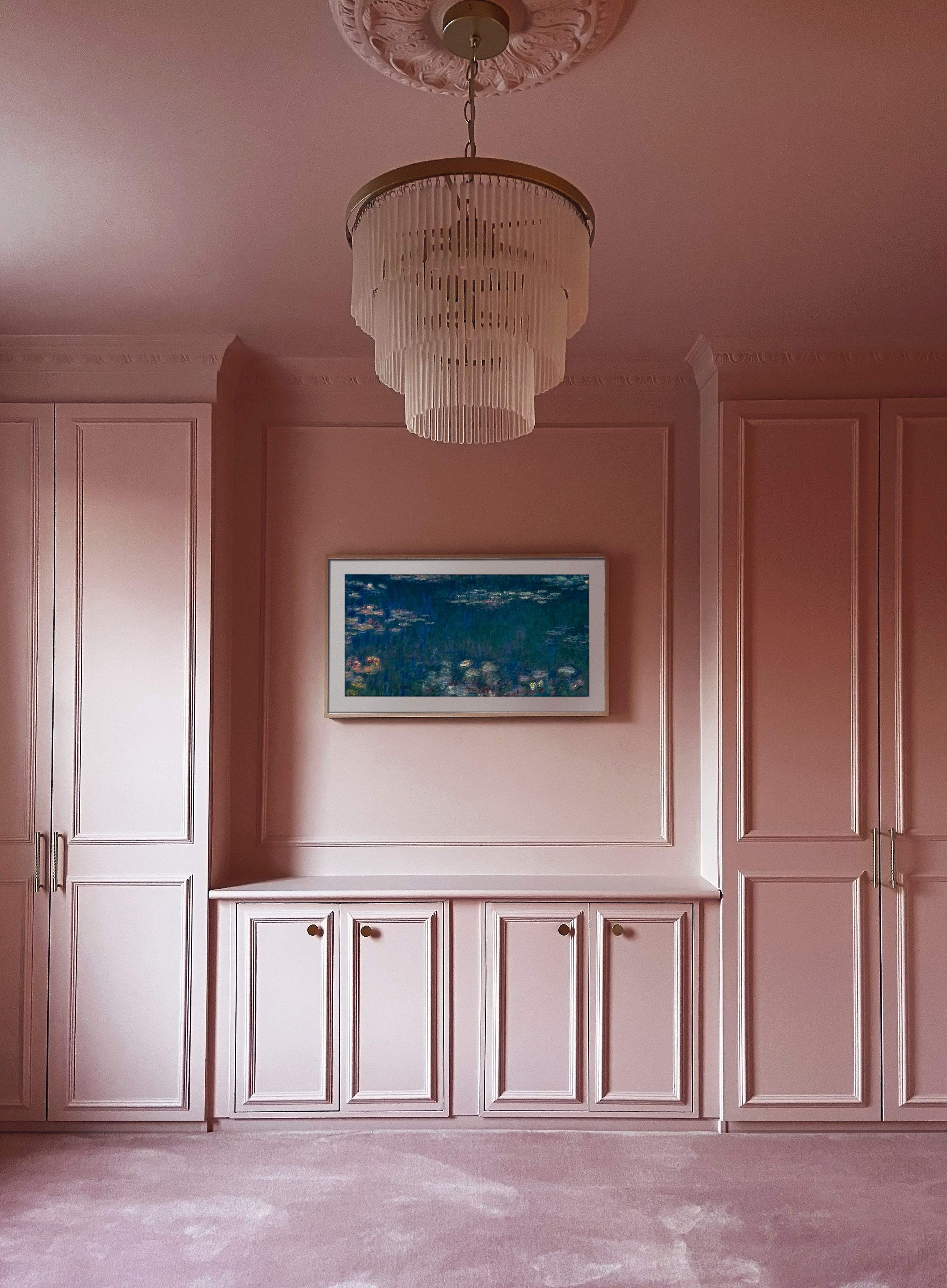 A pink color-drenched bedroom with a built in ikea pax closet with dresser