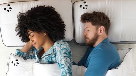 Young couple sleeping on bed with Panda mattress and bedding