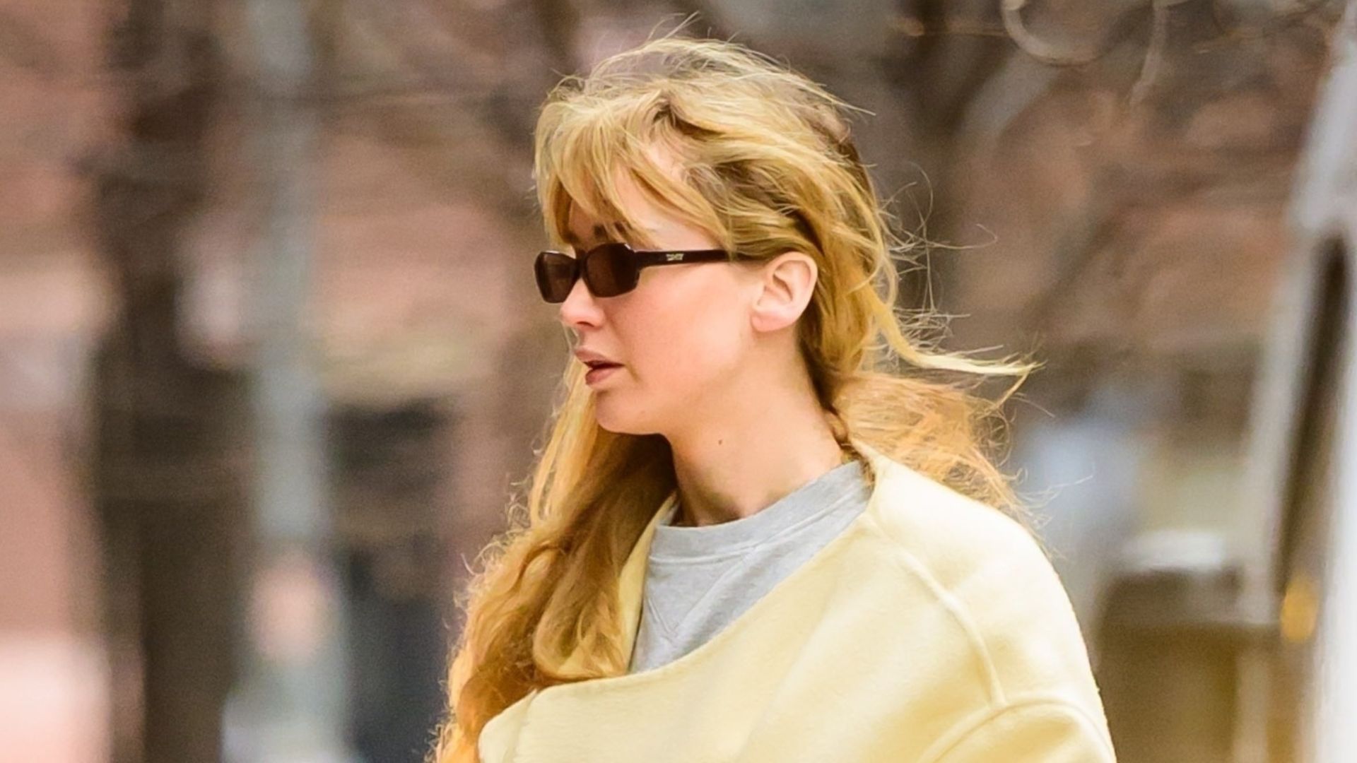 A chic Jennifer Lawrence steps out in NYC looking cozy wearing a maxi yellow coat over her ensemble and Ugg boots. 07/01/2026