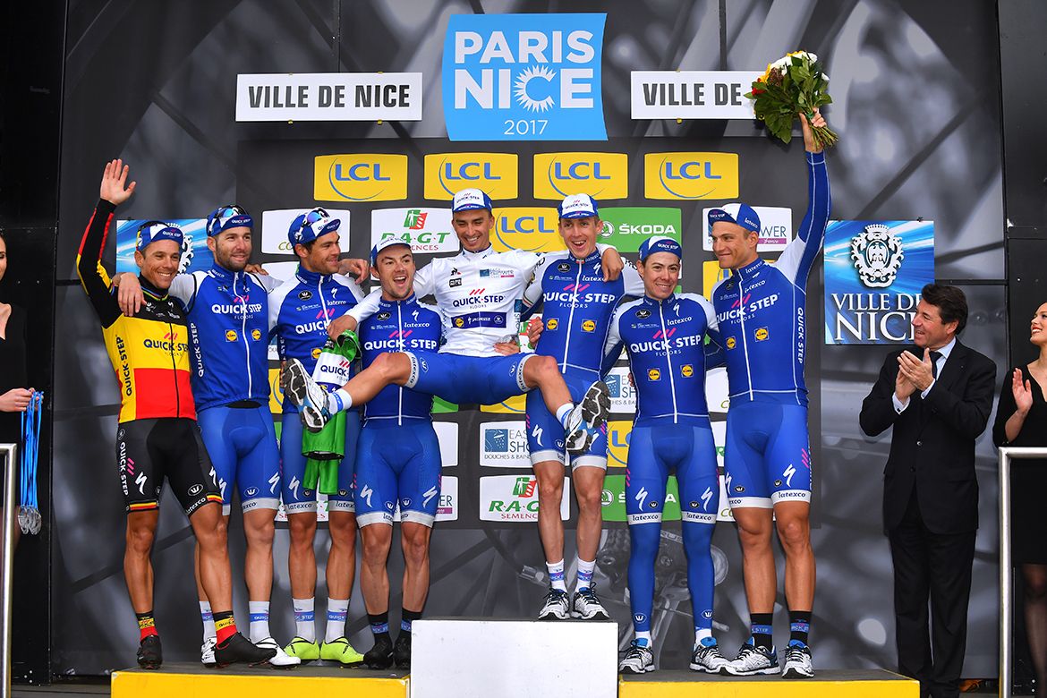 Julian Alaphilippe gets a lift from his teammates on the Paris-Nice podium.