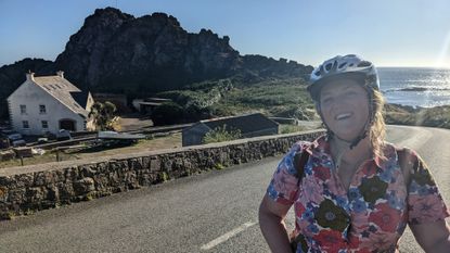 Emmie Harrison-West smiles wearing a helmet in front of a beautiful view