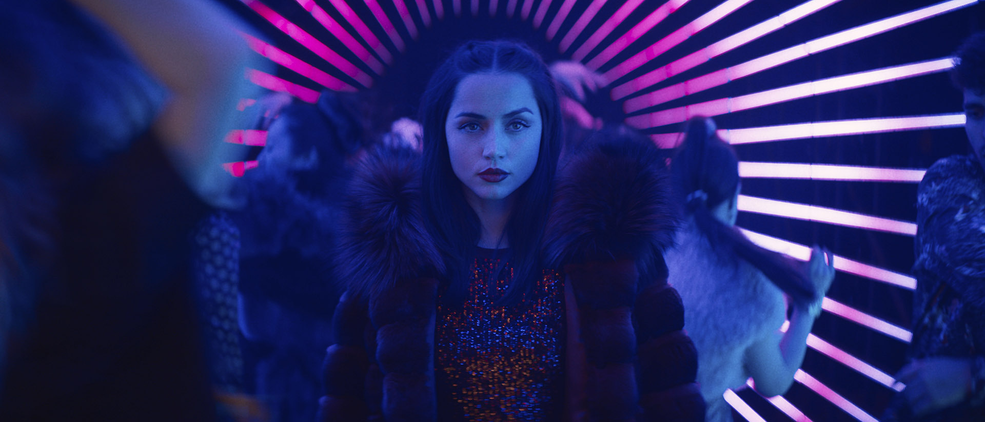 Eve Macarro walking into a neon-lit nightclub in Ballerina