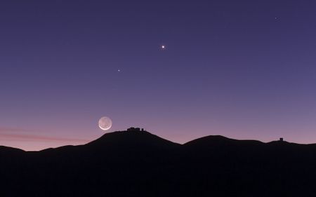 This view shows the thin crescent Moon setting over ESO’s Paranal Observatory in Chile. As well as the bright crescent the rest of the disc of the Moon can be faintly seen. This phenomenon is called earthshine. It is due to sunlight reflecting off the Earth and illuminating the lunar surface. By observing earthshine astronomers can study the properties of light reflected from Earth as if it were an exoplanet and search for signs of life. This picture was taken on 27 October 2011 and also records the planets Mercury and Venus.