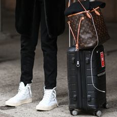 photo of woman carrying luggage