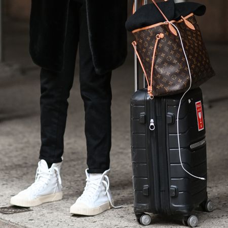 photo of woman carrying luggage 