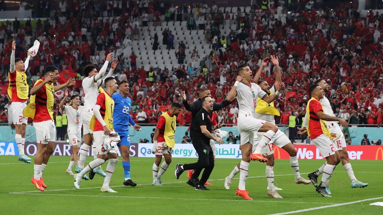 Morocco players and staff celebrate winning group F 