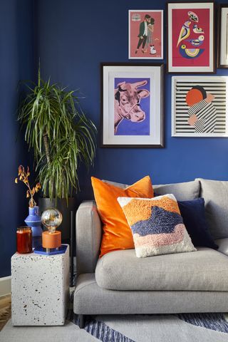 grey sofa with orange and patterned cushions