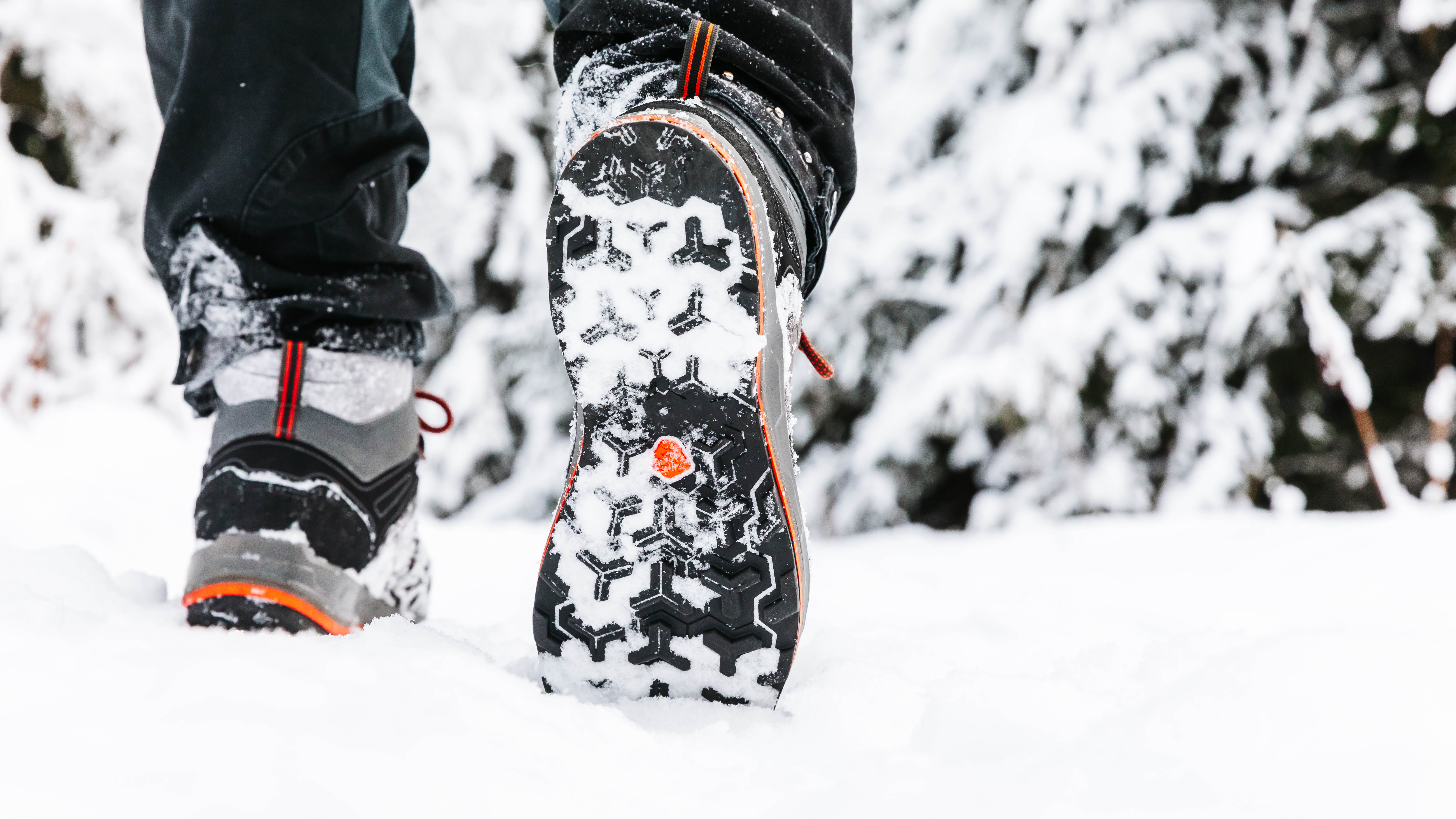 Close-up of a person's sneakers while walking outside in the snow