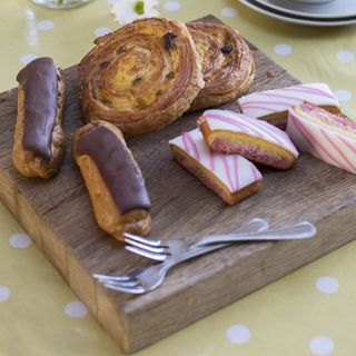 wooden kitchen tray with folk and backed pastries
