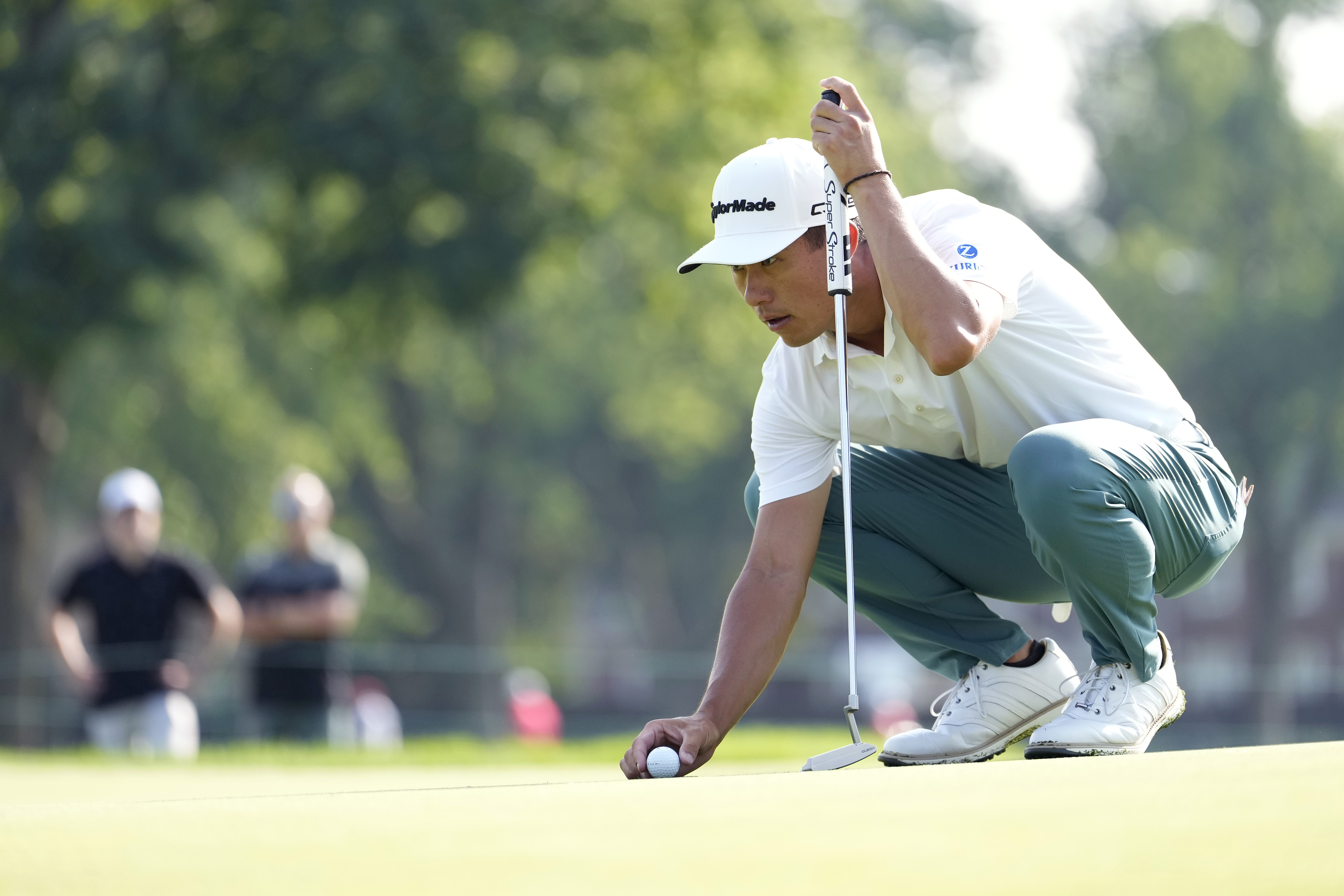 Collin Morikawa lines up a putt