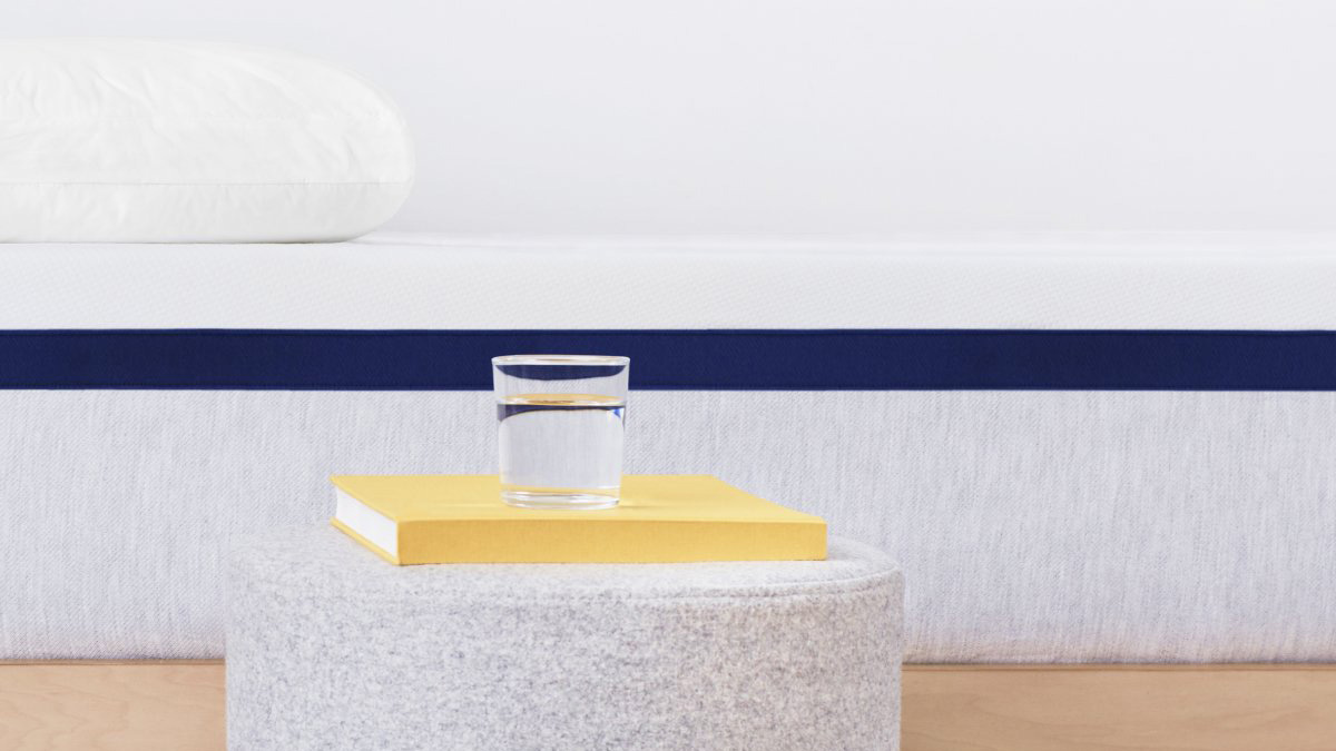 Helix Midnight Mattress review: image shows the mattress from the side with a light gray base, navy mid-band and a white top