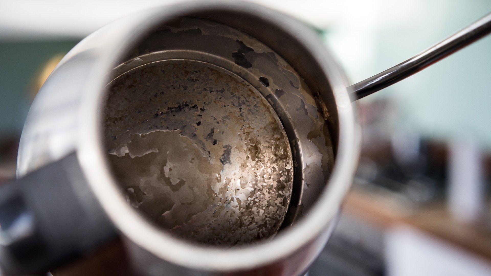 kettle being held up with limescale inside