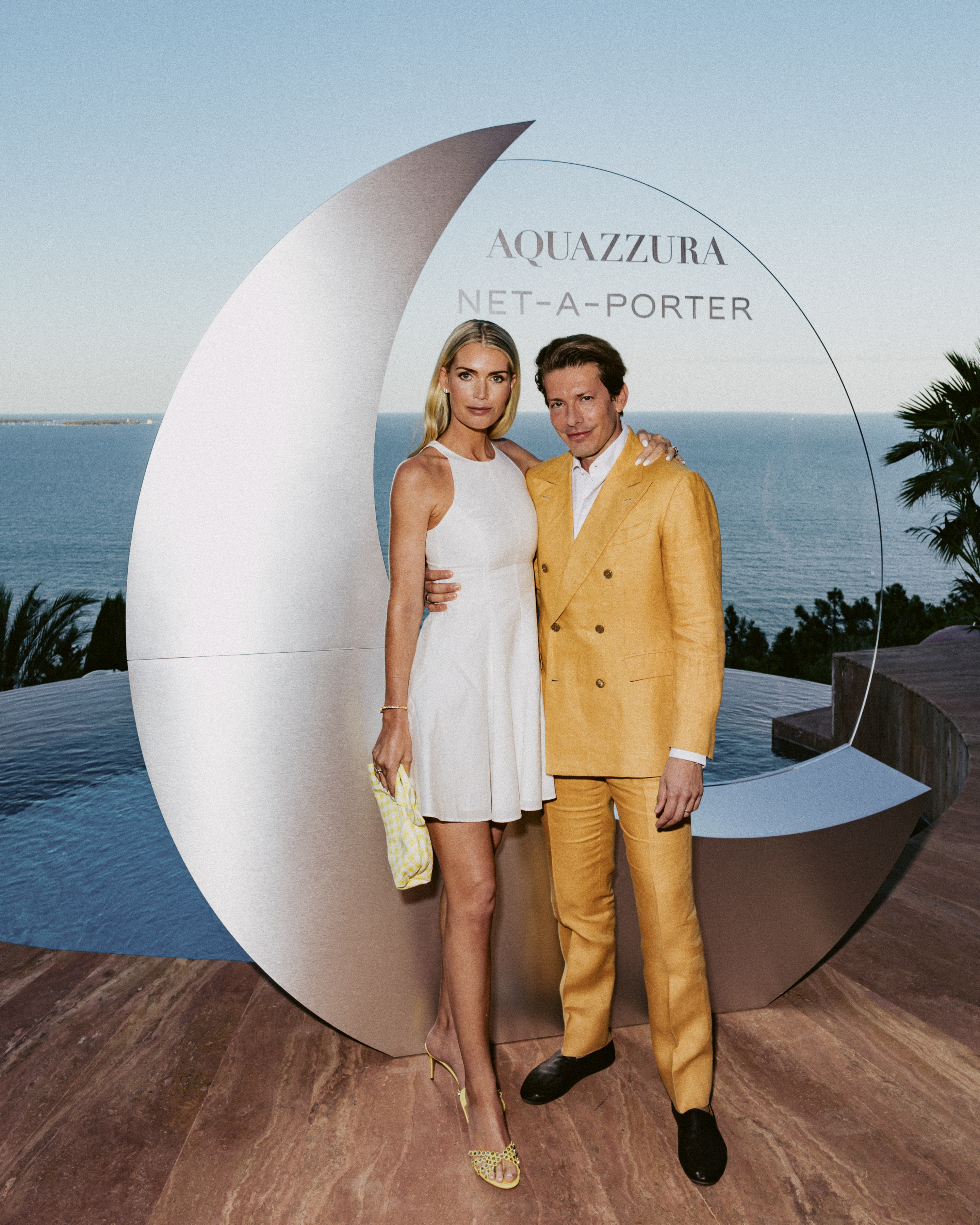 Lady Kitty Spencer, Edgardo Osorio posing in front of a glass Aquazzura Net-a-Porter statue