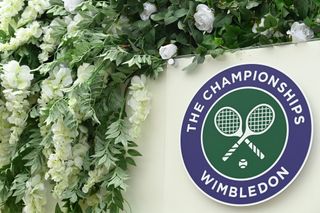 How to watch Wimbledon 2022 online — Wimbledon The Championships logo with flowers around it 