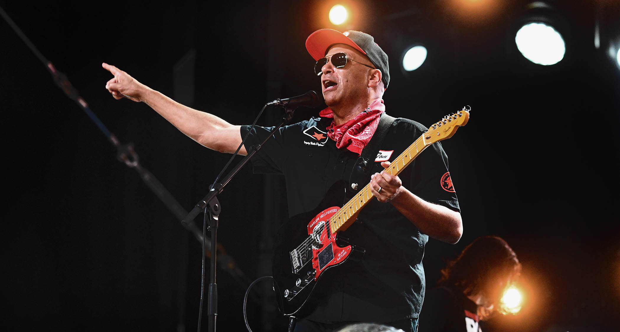 Tom Morello wears shades and a ballcap as he performs with a Tele at a festival.