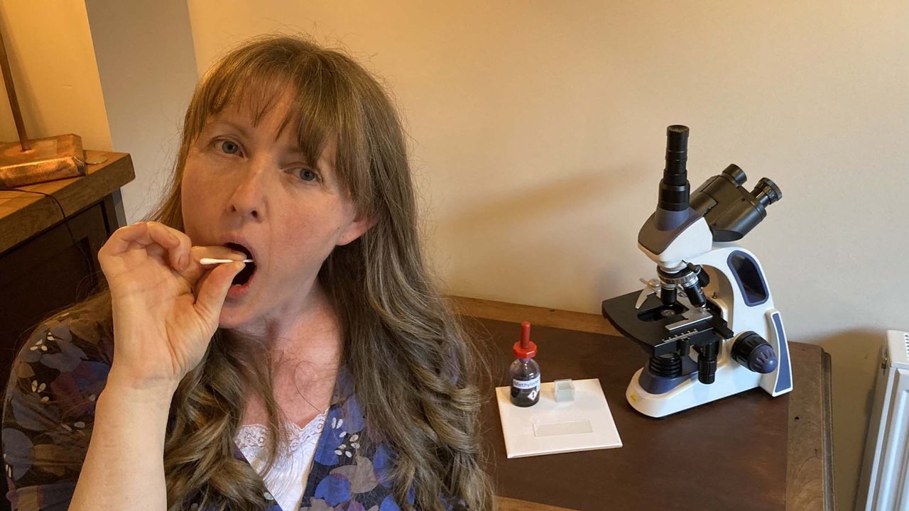 woman taking a cheek swab