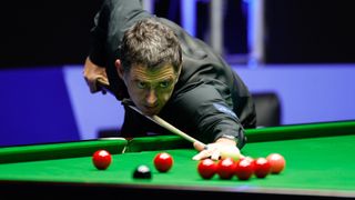 Snooker player Ronnie O'Sullivan of England gets down to play a shot on the pink ahead of the start of the UK Championship 2023