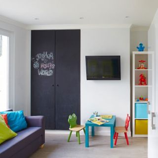 kids play room with wooden flooring and white shelves