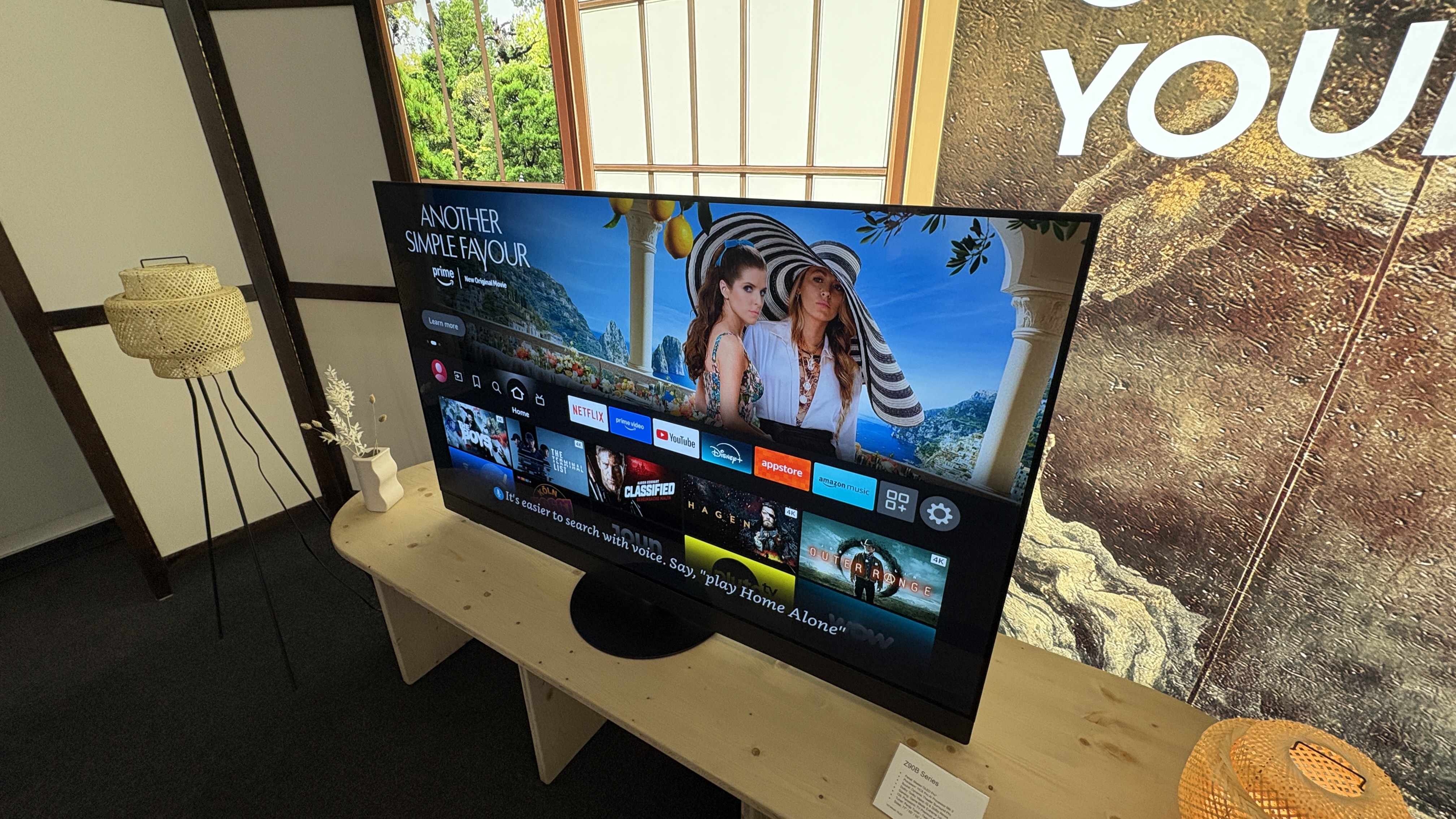 Panasonic Z90B OLED TV on a wooden side table.