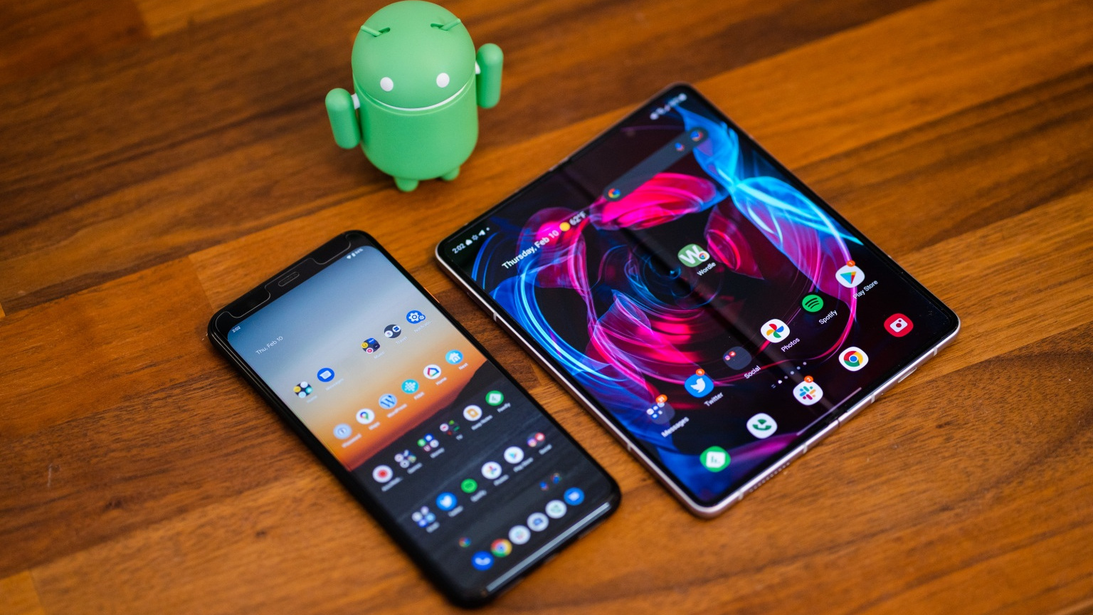 A Google Pixel 4 XL running on Android 13 next to a Samsung Galaxy Z Fold 3, showing the Android 13's tablet-style interface