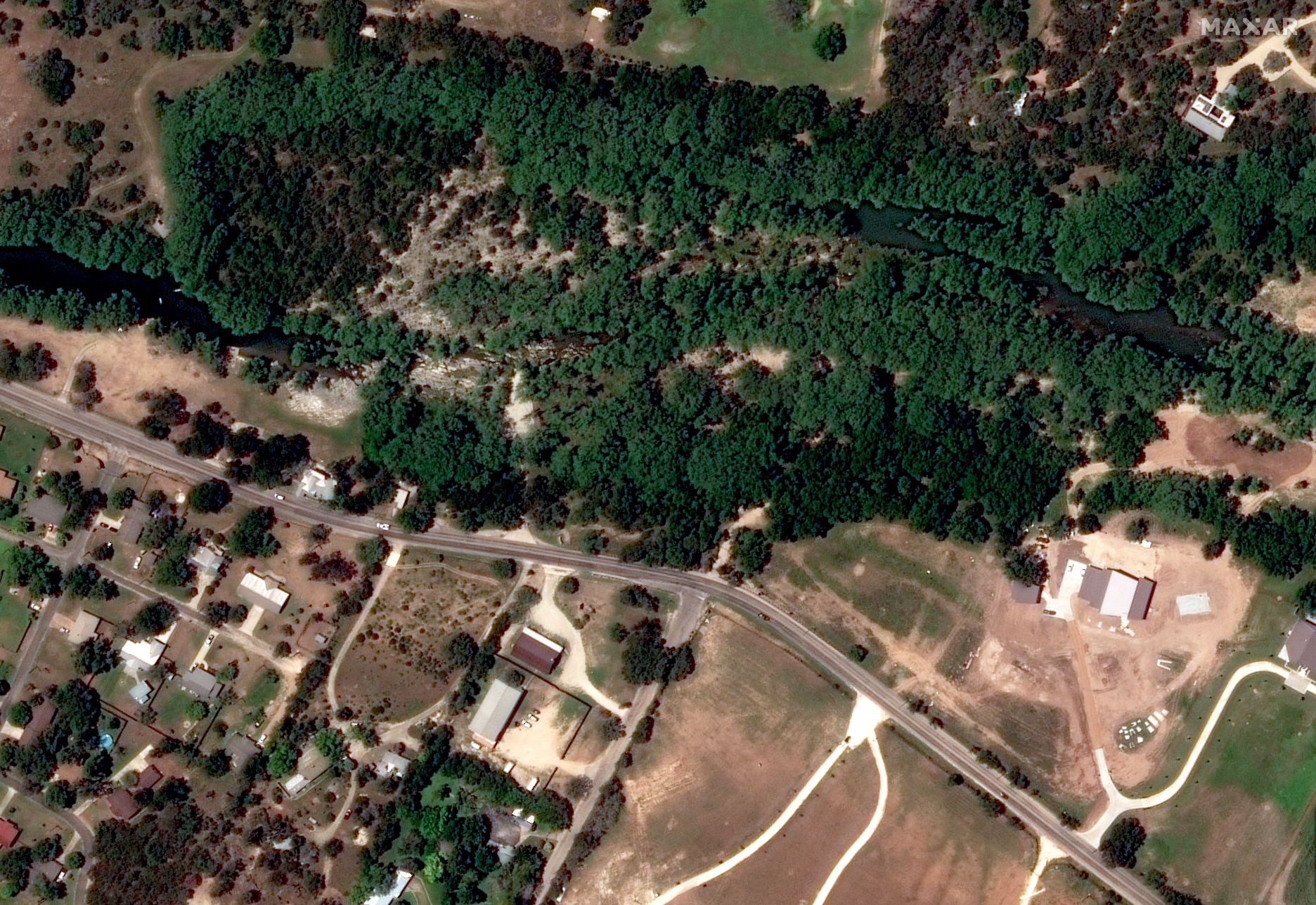 A satellite photograph of trees beside the Guadalupe River on June 23, 2023.