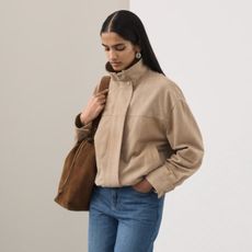 Image of the Marks and Spencers Spring Fashion trends 2026. The model wears a tan suede funnel-neck jacket.