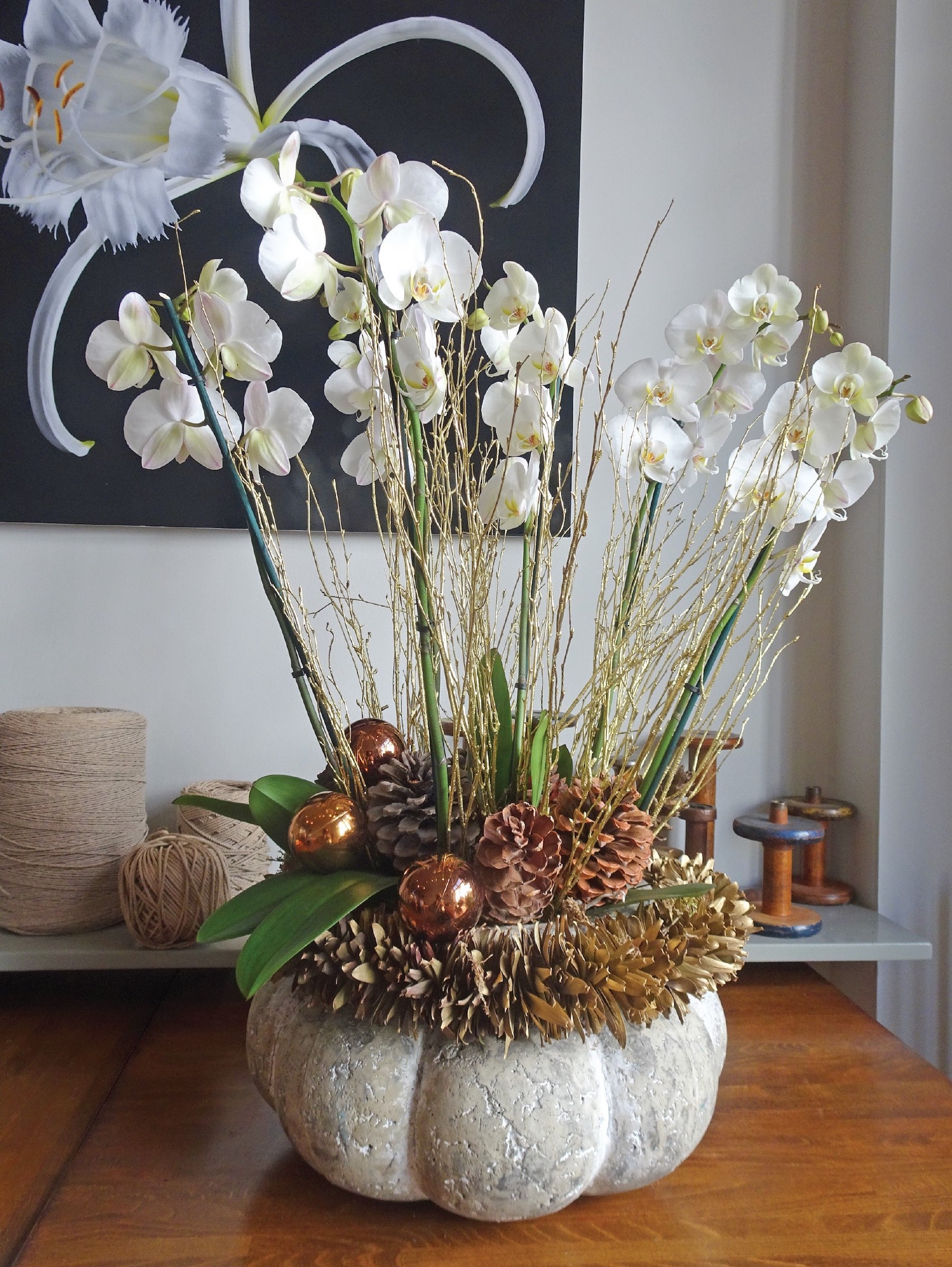 orchid and pine cone display