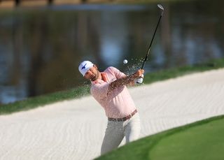 Greyson Sigg hits a bunker shot