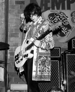 Jimmy Page onstage with violin bow, 1967