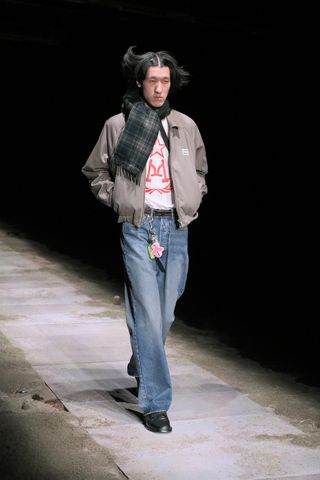 Magliano A/W 2025 runway show featuring model in jeans and checked scarf