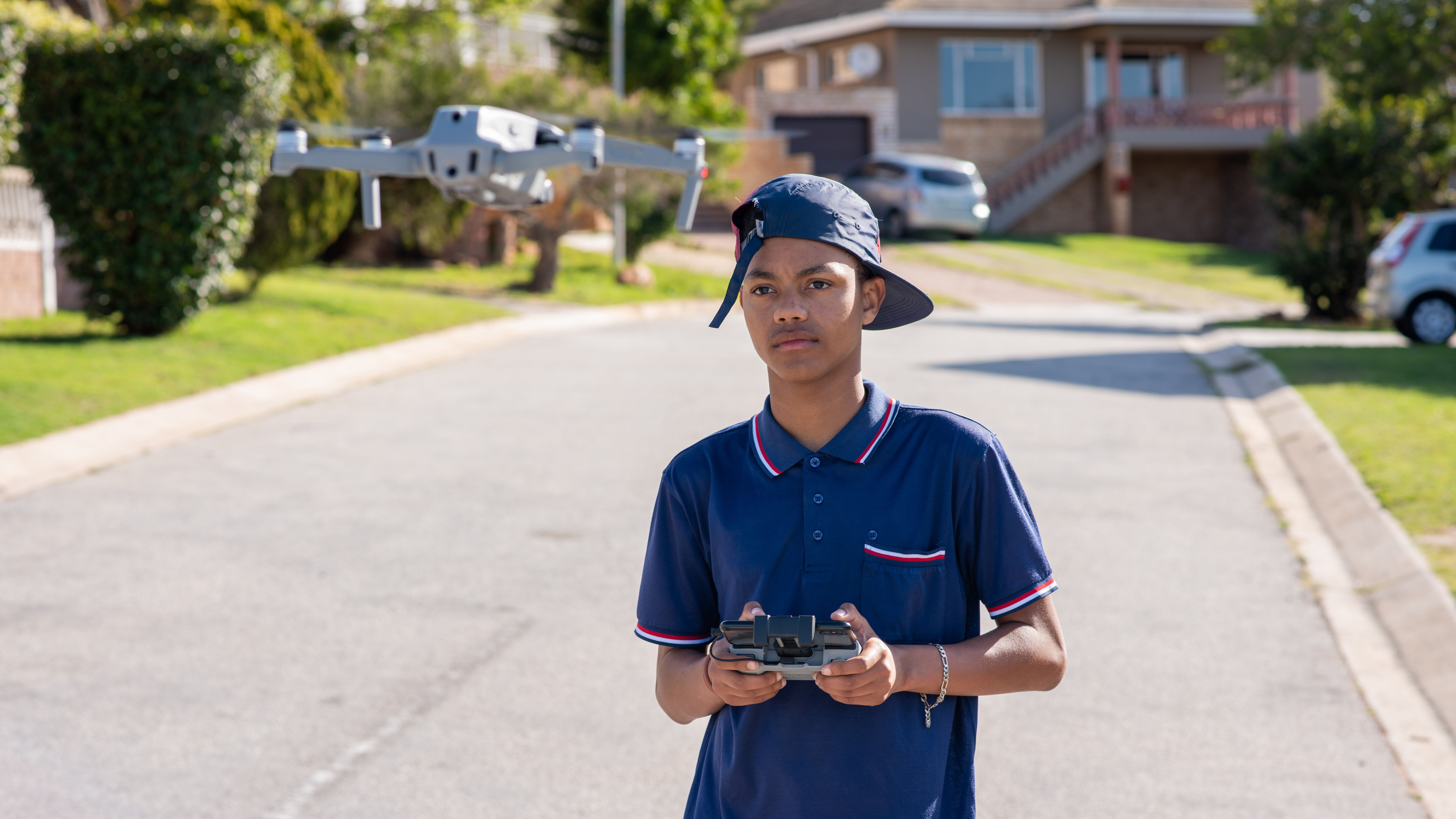 Young boy flying drone