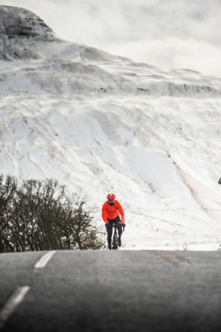 Rider crests a climb in the snow