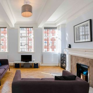 chiltern baker street h g wells home living room with sofa with cushions radiator tv and window