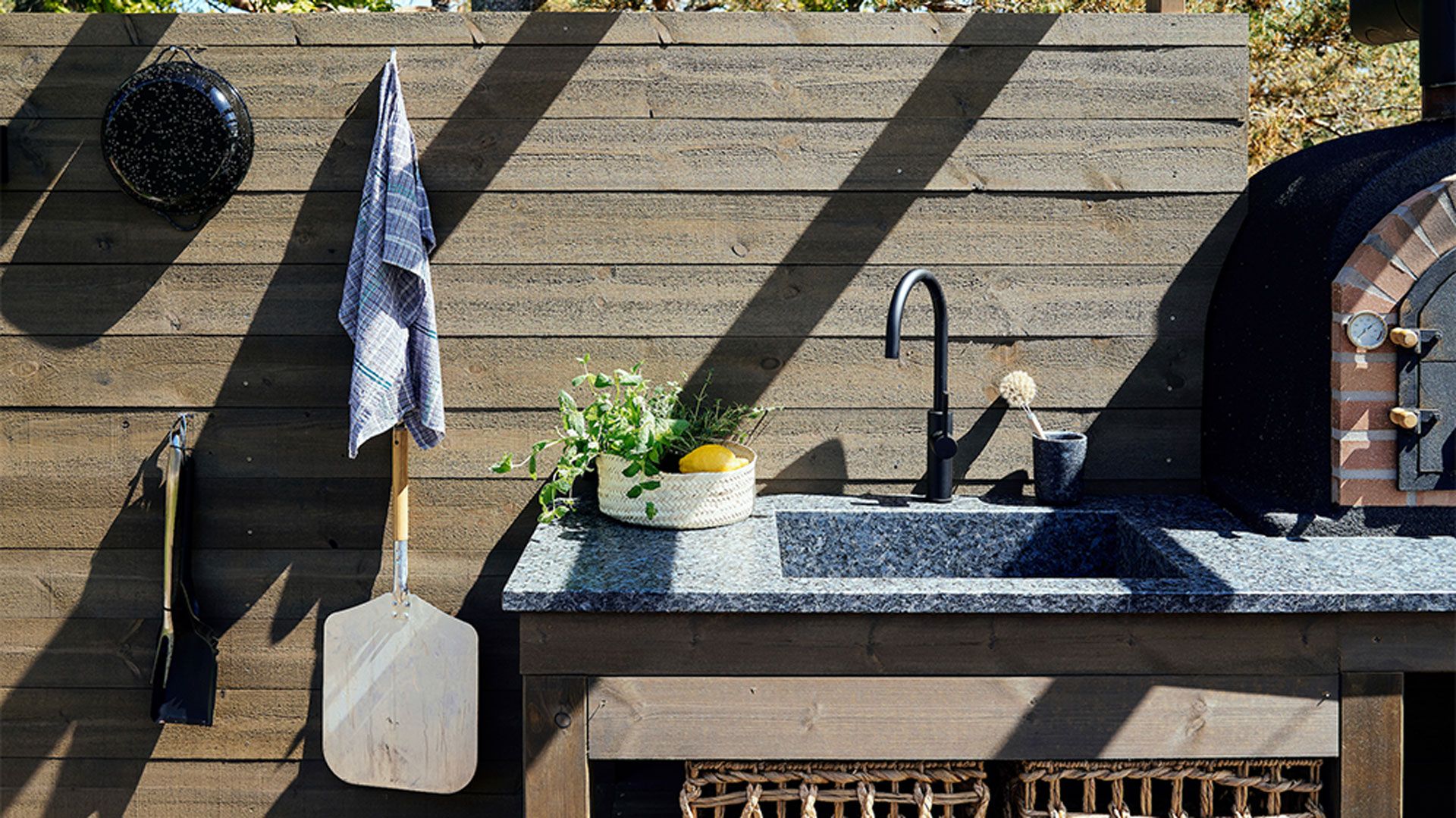Outdoor kitchen ideas with stone integrated sink