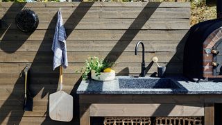 Outdoor kitchen ideas with stone integrated sink