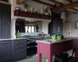 Grey kitchen with painted cabinets and pink island