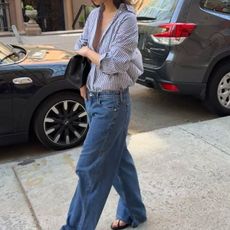 Woman in low-rise wide-leg jeans and a button-down