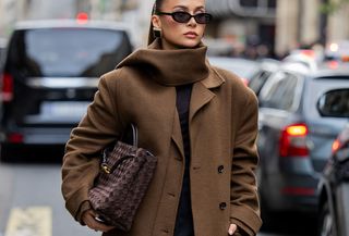 Woman in brown scarf coat.