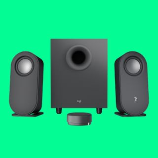 The Logitech Z407 2.1 speakers on a green background