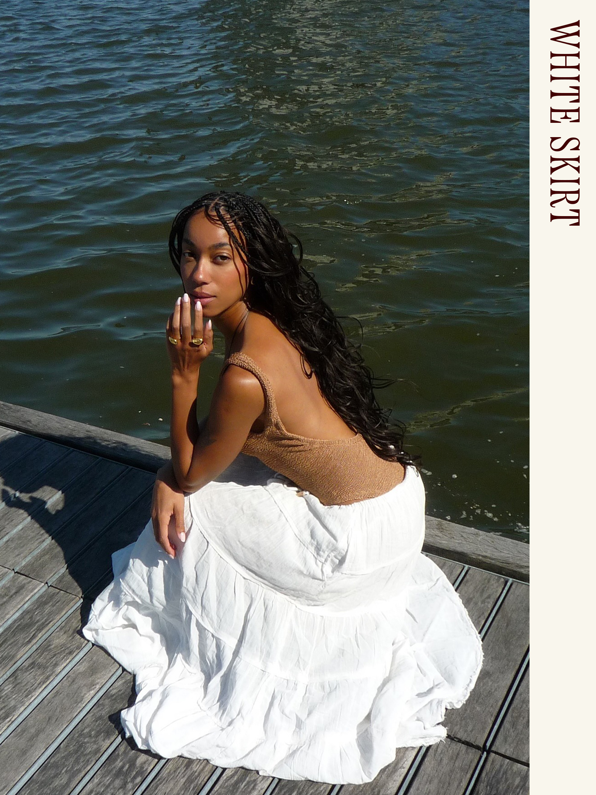 Influencer wearing a swimsuit and long white skirt