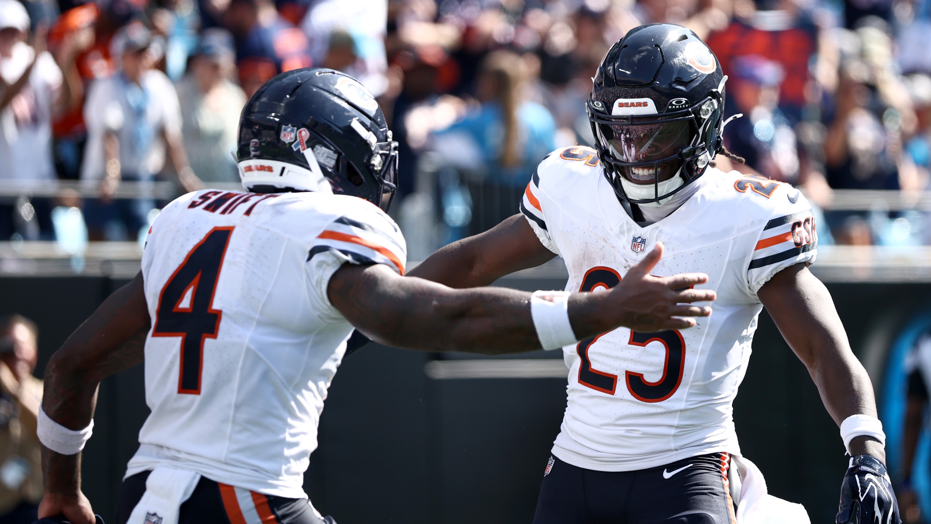 Kyle Monangai #25 of the Chicago Bears celebrates after scoring a touchdown with D'Andre Swift #4 during an NFL match in 2026.