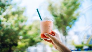 Smoothie in glass with straw