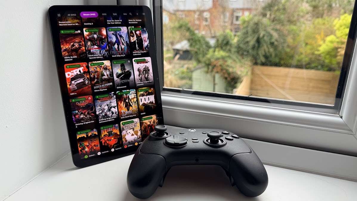 Gaming tablet on a windowsill next to a controller