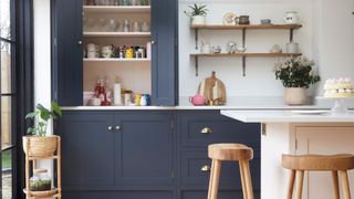 organizing kitchen countertops in navy blue kitchen cupboards for streamlined kitchen work surcaes