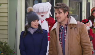 John Reardon and Meghan Ory walk through town during Christmas.