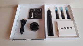 AENO DB2S Smart Sonic Toothbrush in box with three spare heads and wireless charging platform