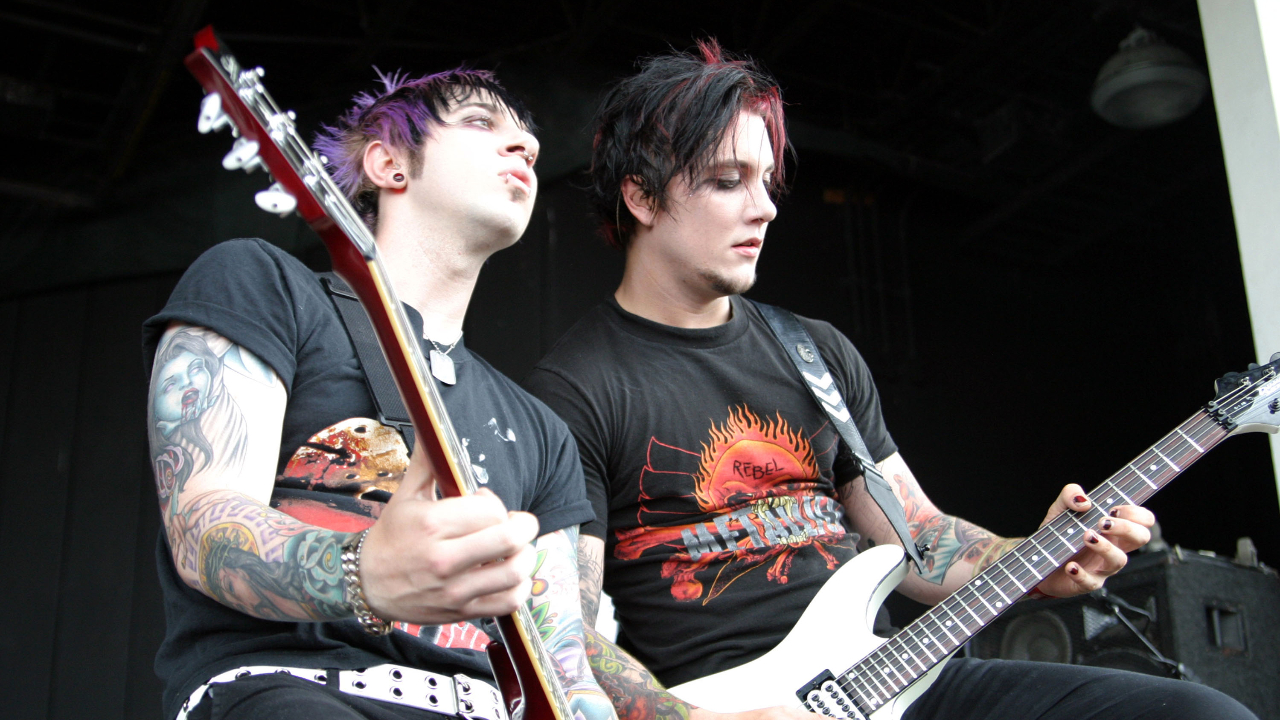 Zacky Vengeance and Synyster Gates playing guitar on stage