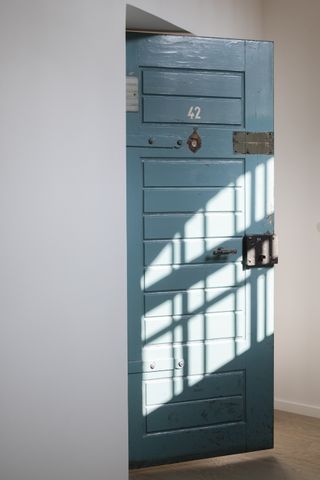 old blue door in white room