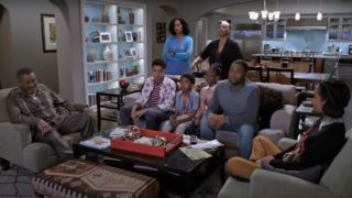 The cast of Black-ish sitting around the TV