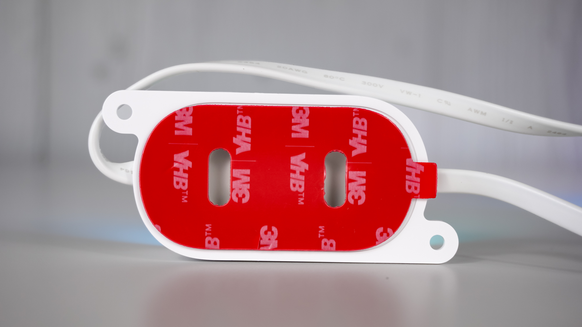 The backside of one of Govee&#039;s new Prism lights showing off its adhesive tape and two screw holes